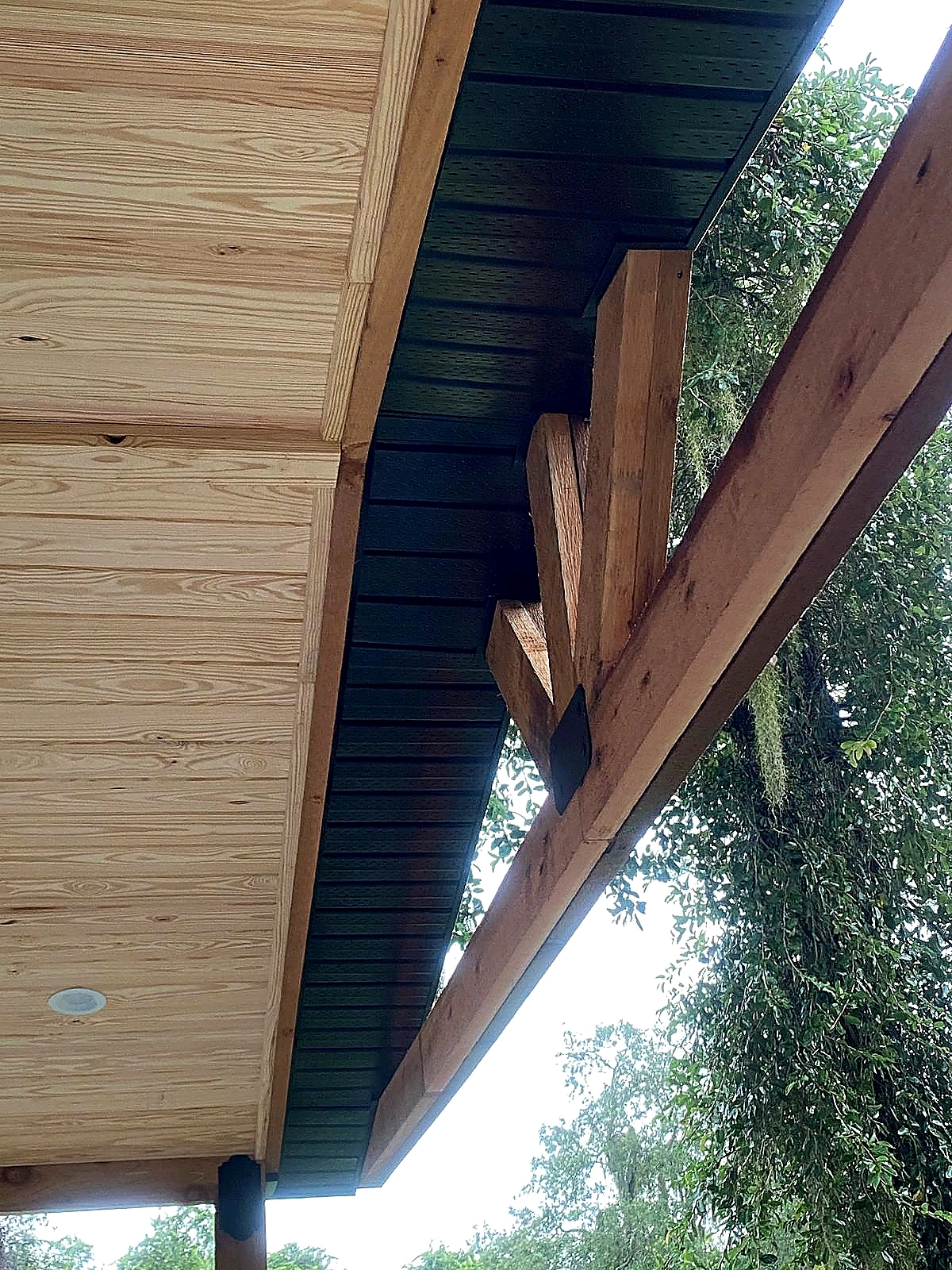 Wood timber construction beams alongside dark soffit
