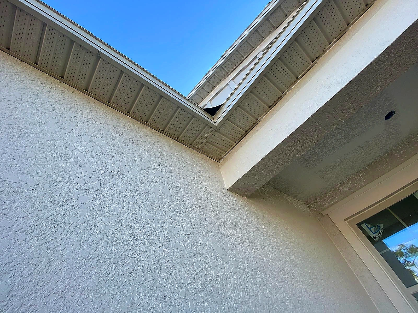 White ventilated soffit installed at a residential courtyard